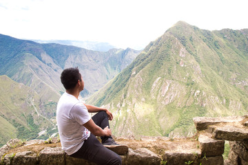 Naklejka na ściany i meble Traveller at the Lost city of the Incas, Machu Picchu,Peru on top of the mountain, with the view panoramic