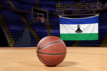 Lesotho flag and basketball on Court Floor