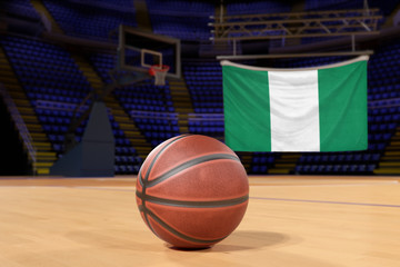 Naklejka premium Nigeria flag and basketball on Court Floor