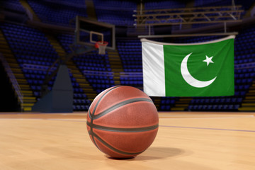 Naklejka premium Pakistan flag and basketball on Court Floor