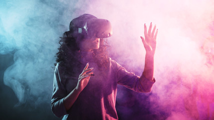 Virtual reality game. A girl in a virtual reality helmet plays a game or explores the environment.