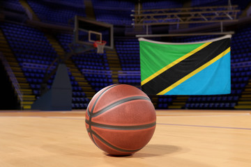 Naklejka premium Tanzania flag and basketball on Court Floor