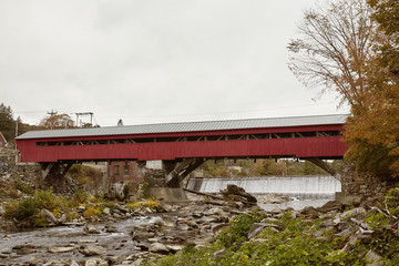 Historic Taftsville Covered Bridge surrounded by Fall foliage in Woodstock, Vermont