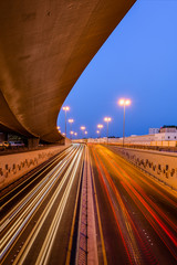 Beautiful light trails of fast-moving traffic at the blue hour in Bahrain