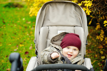 Baby boy in warm in modern stroller
