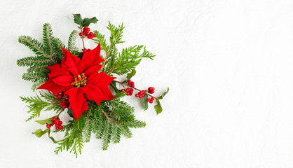 Christmas decoration with poinsettia flowers and holly berry on white background. Festive winter...