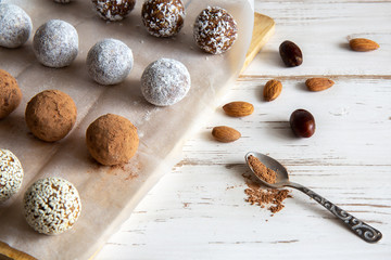 Energy balls with nuts and cocoa on a white background