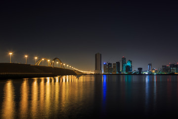 Beautiful view of Sheikh Khalifa bridge and Jufffair skyline with reflection at night, Bahrain.