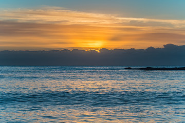 Fototapeta na wymiar Colourful Streaky Clouds Sunrise Seascape