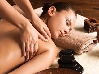 Obraz na płótnie Canvas Beautiful woman relaxing with back massage at spa salon.