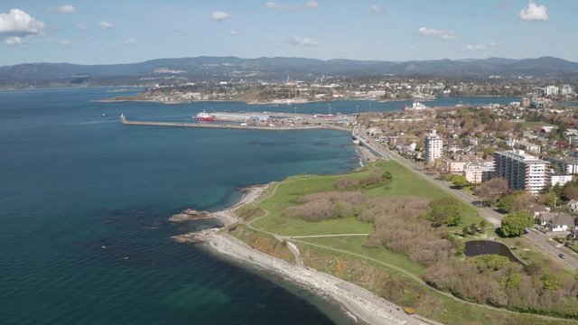 Beacon Hill Park coastline and Victoria city background, Canada, aerial view