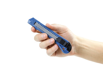 Hand holding a blue stationery knife. Close up. Isolated on white background