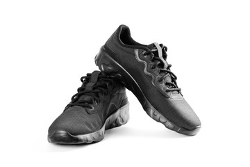 Black sports women's running shoes. Close up. Isolated on white background