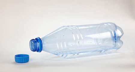 Blue bottle with drinking water. Close up. Isolated on white background