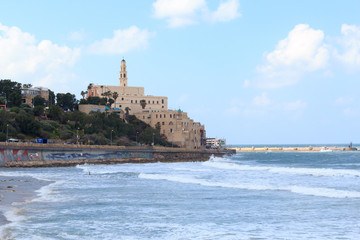 Fototapeta na wymiar Coastline panorama of city Tel Aviv Jaffa with mediterranean sea and St. Peters Church in Israel