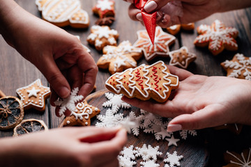 Christmas bakery. Family cooking sweets, decorating traditional gingerbread cookies. Weekend...