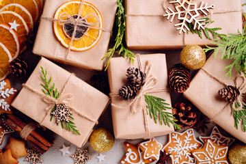 Christmas composition with gift boxes, festive decorations and gingerbread cookies on stone...