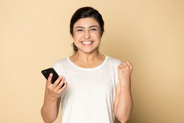 Overjoyed indian girl feel excited getting pleasant cellphone message