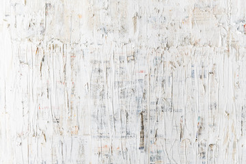 Rough white painted on newspaper wall. Perfect for background. Abstract  texture. White wallpaper.
