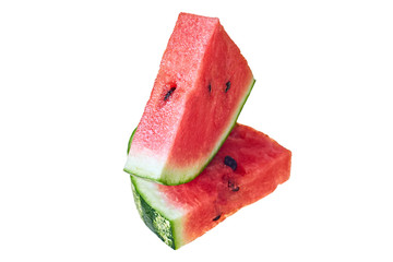 Two slices of fresh watermelon in form of triangle with red ripe juicy pulp and seeds isolated on white background without shadow