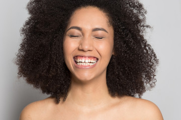 Fototapeta na wymiar Close up of happy biracial girl smiling showing white teeth