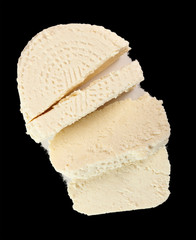 Capreggio Goat Cheese. Isolated on black background. Directly Above.
