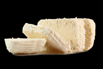 Capreggio Goat Cheese. Isolated on black background.