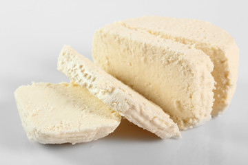 Capreggio Goat Cheese. Isolated on gray background.