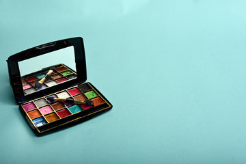 eye-shadow palette isolated on blue background