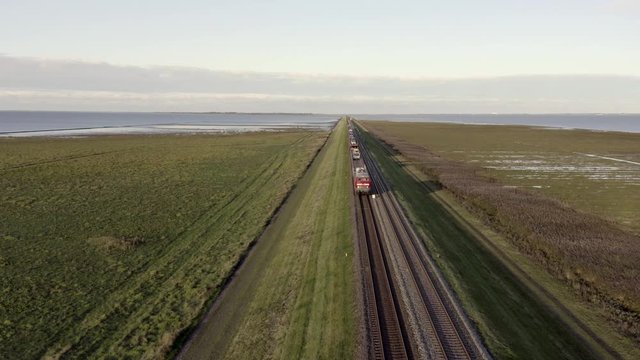 Moto Rail Train Carrying Vehicles and Passengers on a Journey
