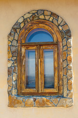 Arched wooden window in a wall