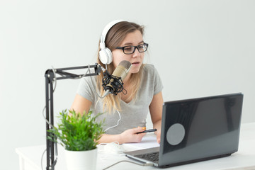 Radio host, streamer and blogger concept - Woman working as radio host at radio station sitting in...
