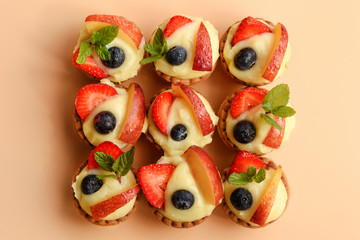 9 chiffon/cream cakes basket with fruits, top view.