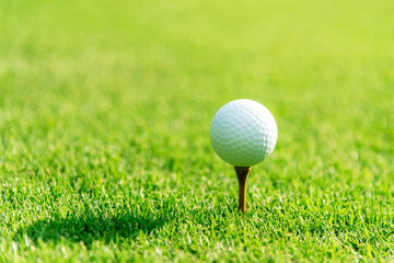 Close up Golf club hitting golf ball along fairway towards green with copy space, green nature background. Lifestyle and Healthy Concept. ...
