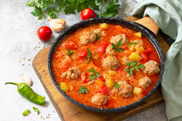 Spanish and Mexican food - Albondigas. Hot stew tomato soup with meatballs and vegetables. Free space for your text. - obrazy, fototapety, plakaty