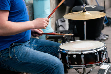 Creation. A man plays a drums on the street