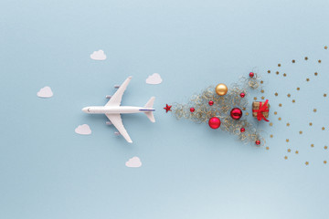 Christmas composition. Airplane flying in sky star gift bauble top view background with copy space for your text. Flat lay