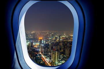 Fototapeta na wymiar Airplane window view of bangkok city with night time. Concept of travel and air transportation