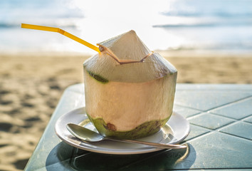Fresh coconut juice on the beach. Summer concept