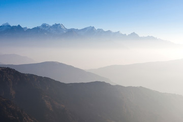 Naklejka na ściany i meble Misty landscape in himalayas. Foggy mountain shapes. Beautiful view on everest base camp track.