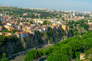 Fototapeta na wymiar Beautiful view of the houses on the edge of the cliff on the Kura river in Tbilisi