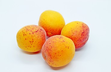 Ripe tasty juicy apricots located on a white background