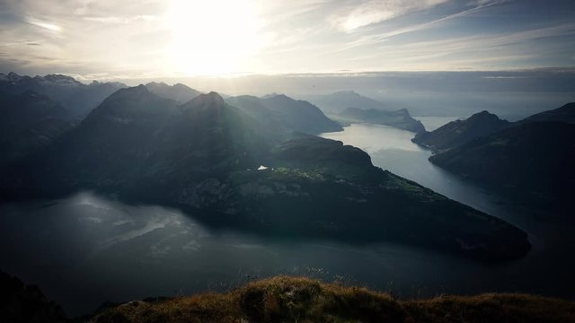 Timelapse - Golden sunset over Swiss Alsp Mountains by the Lake of Four Cantons near Luzern, Ship movement recorded.
