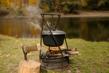 Hiking pot, Bowler in the bonfire. Fish soup boils in cauldron at the stake.