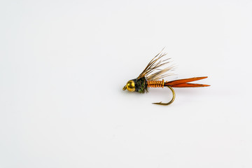 close up of brass gold head trout and salmon fishing fly lure with copper wire body