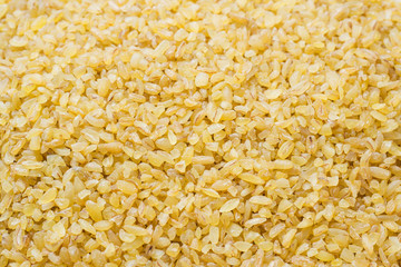 Traditional Turkish dry raw bulgur cereals. Background Close up.