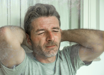 Obraz premium dramatic portrait of sad and depressed 30s or 40s man in pain feeling stressed and broken suffering depression problem and anxiety crisis looking desperate crying lonely