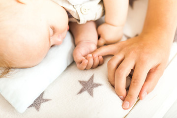 Baby and mothers hands close up. Family concept
