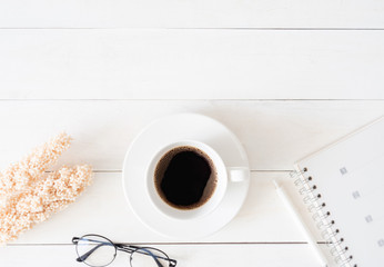 top view of office desk table with coffee cup and notebook on white background, graphic designer, Creative Designer concept.