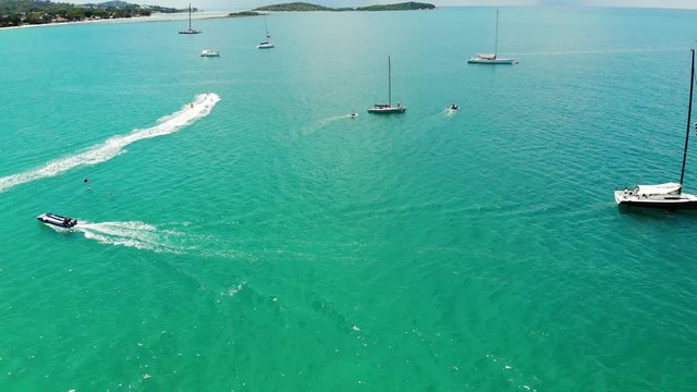 Modern boats taking part in race. Modern yachts and motorboats taking part in regatta in clean blue sea on sunny day. Koh Samui paradise island, Thailand. Drone view. Relax, sport and holiday concept